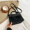 Black crinkled leather crossbody satchel with gold buckles and round top handle - Black