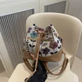 Floral jacquard and tan leather drawstring bucket bag with gold zipper pocket - Khaki
