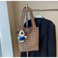 Detail of multi-color woven houndstooth tote bag with a cute white puppy plush charm - With Pendant / Brown
