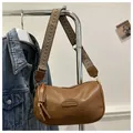 Detail of a brown PU leather shoulder bag with FASHION patch and woven strap - Brown