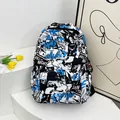 Graffiti printed street style backpack in black and blue with astronaut charm detail - Blue