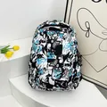Streetwear backpack with comic graffiti print in black blue white and astronaut charm - Green