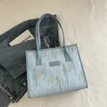 Light blue tote bag with diamond lattice pattern and colorful wavy embroidery - Blue