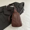 Deep coffee pleated faux leather sling bag with adjustable strap and zipper closure - Brown