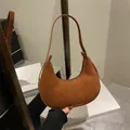 Brown suede crescent bag with shoulder strap in a stylish minimalist saddle design - Brown