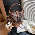 Leopard print bucket bag with brown leather trim and fur pompom charm details - With Pendant / Brown