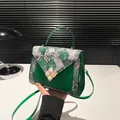 Green faux leather handbag with snake pattern and pearl flower clasp detail - Green