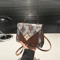 Brown faux snakeskin crossbody bag with square gemstone buckle and top handle style - Brown