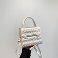 Minimalist creamy white square bag with 3D geometric texture and golden zipper detail - White
