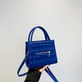 Klein blue faux leather square bag with quilted texture and golden zipper detail - Blue