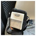 Black and white patchwork canvas crossbody bag with clear PVC pocket and logo label - Black