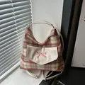 Pink and grey plaid tote bag with bow embroidery and white PU pocket on a window sill - White