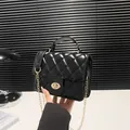 Classic black quilted crossbody bag with gold chain strap and rotary lock handle - Black