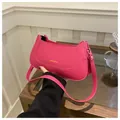 Detail of rose pink matte leather crossbody bag with golden lettering and precise stitching - Rose Pink