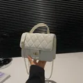 Elegant white quilted crossbody bag with gold chain strap and stylish top handle - White