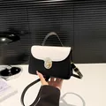Chic black and white colorblock crossbody bag with gold buckle and top handle - White