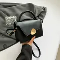 Minimalist black trapezoid handbag with gold pebble buckle and adjustable strap - Black