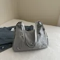 Silver metallic crossbody bag with textured pleats and silver butterfly charms - Silver