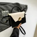 Chic black and beige contrast handbag with gold hardware and adjustable strap - White
