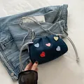 Dark blue denim crossbody bag with colorful heart patches and silver chain strap - Blue