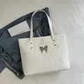 Chic white pleated tote bag for women featuring a stylish silver butterfly buckle - White
