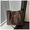 Detail of houndstock pattern fabric and gold chain strap on a large tote bag - Brown