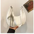 White crinkled patent leather crescent bag with silver beaded tassels and fashion detail - White