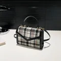 Classic black and white houndstooth tweed crossbody bag with gold hardware and top handle - Gray