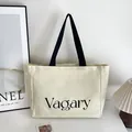 Sac fourre-tout minimaliste en toile crème avec imprimé noir Vagary et anses - Style Imprimé Lettres (Vagary) / Blanc Cassé