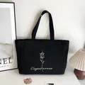 Sac fourre-tout en toile noire minimaliste avec rose blanche et texte Elegant Woman - Style Imprimé Rose (Elegant woman) / Noir