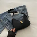 Borsa a spalla a mezzaluna nera minimalista con chiusura dorata e pelle opaca chic - Nero