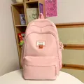 Sac à dos scolaire rose minimaliste avec étiquette mode et badge sourire pour élèves - Rose