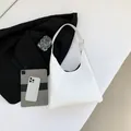 Minimalist white leather hobo bag with embossed lettering and metal buckle strap - White