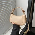 Detail of beige hobo bag showing the knot handle design and adjustable shoulder strap - Khaki