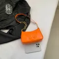 Chic orange patent leather shoulder bag with embossed butterfly and gold chain strap - Orange