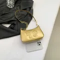 Metallic gold butterfly embossed shoulder bag with chain strap and zipper closure - Gold
