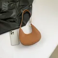 Brown faux leather crescent shoulder bag with gold zipper and minimalist strap - Brown