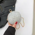 Silver rhinestone spherical evening bag with golden ring handle and delicate chain strap - Silver