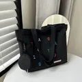Black canvas tote bag with colorful letter embroidery and mini coin purse attachment - Black