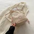 Beige woven bucket bag with pink drawstring closure and gold chain shoulder strap - With Pendant / Pink