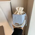 Blue marble texture bucket bag with large pearl handle and gold chain strap for women - Blue