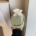 Light green pleated bucket bag with large pearl handle and golden chain strap - Green