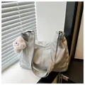 Detail of silver metallic tote bag with pink plush puppy charm and smooth zipper - With Pendant / Silver