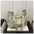 Detail of light green tote bag with matte texture placed on a white design book - No Pendant / Green