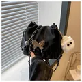 Detail of black pleated bucket bag with silver butterfly charm and plush doll pendant - Black With Pendant