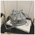 Detailed view of silver drawstring bucket bag with metallic butterfly and chain strap - Silver Without Pendant