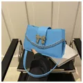 Light blue PU leather shoulder bag featuring a silver bow buckle and metal chain strap - Blue