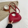 Chic red crescent moon bag with woven texture and gold hardware details - Red