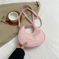 Pink woven crescent bag with adjustable shoulder strap for casual fashion styles - Pink