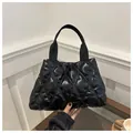 Chic black quilted tote bag with a glossy diamond pattern finish and wide strap - Black